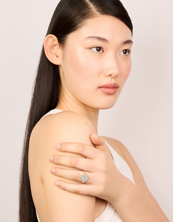 Featuring a statement ring in gold plated cubic zirconia with textured square design on finger view