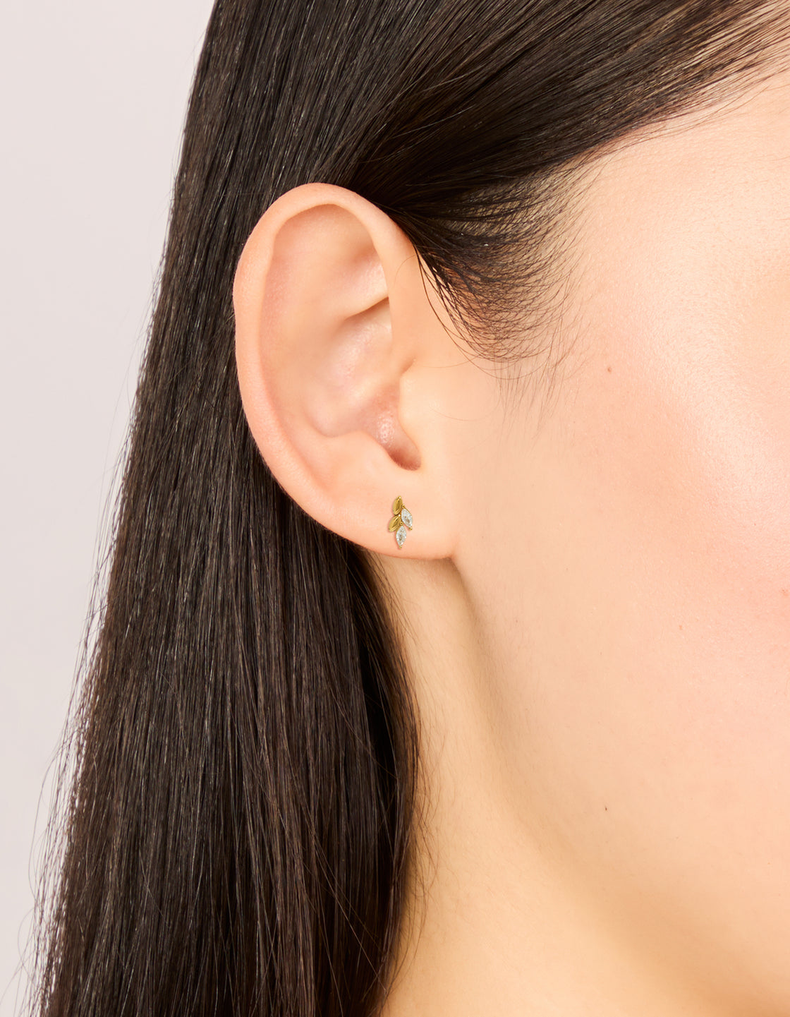 Elegant waterproof vine earrings featuring leaf design, cubic zirconia accents, gold plated stainless steel material, and flat back closure on ear view