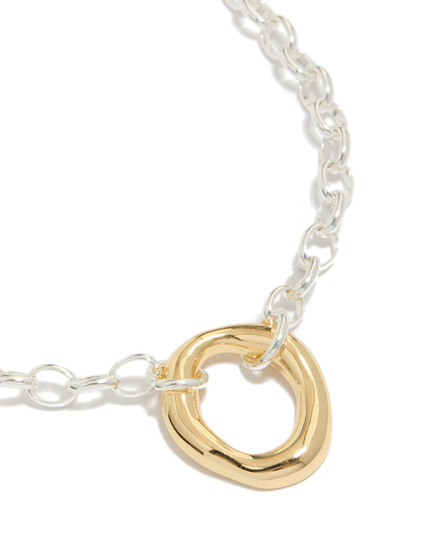 Showcasing a waterproof mixed metal plated stainless steel organic round pendant necklace in gold and silver close up view