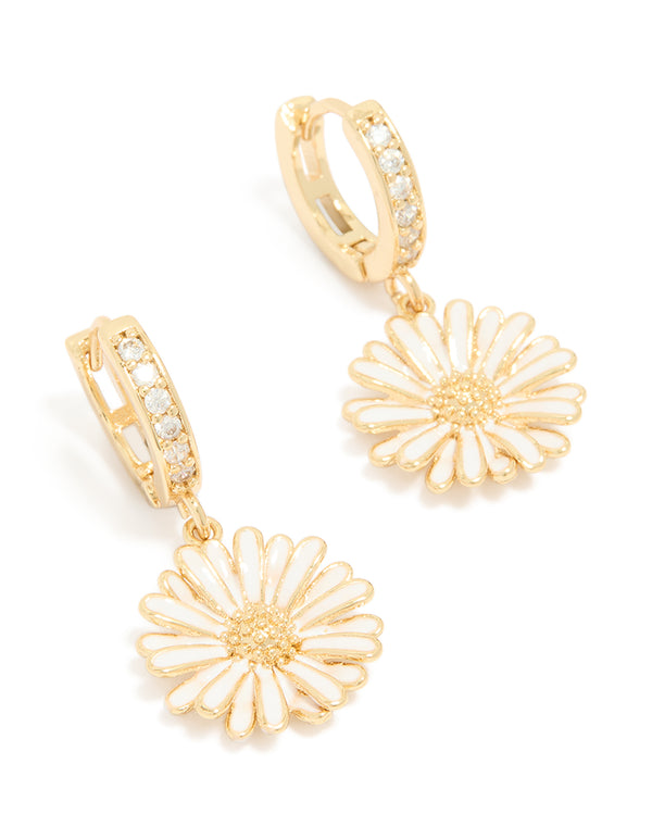 Showcasing statement floral huggie earrings with gold plated finish, white enamel petals, and cubic zirconia accents front view