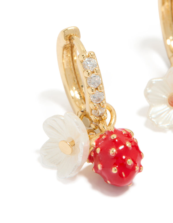 Showcasing gold plated cubic zirconia flower strawberry huggie earrings with charm in red ivory white close up view