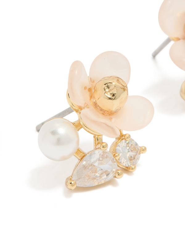 Beautifully crafted gold plated cubic zirconia and pink acrylic flower stud earrings featuring pear cut crystal and pearl in white close up view