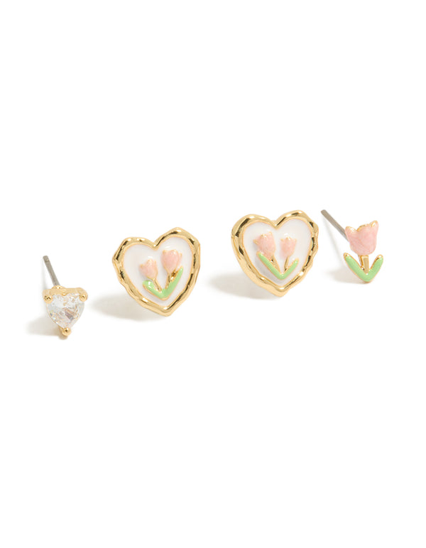 Designed with a 3-pack of stud earrings featuring floral with heart accents crafted from enamel and cubic zirconia in gold plated finish with pink, light green, and white details close up view