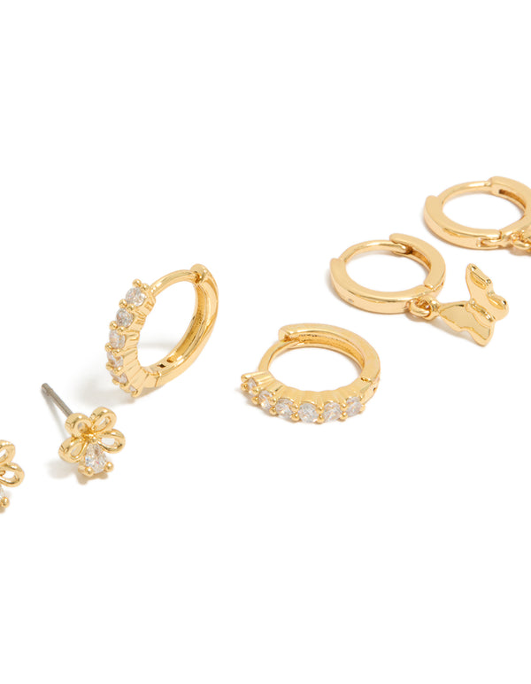 Explore dainty gold plated cubic zirconia bow and butterfly huggie earrings in a 3-pack close up view