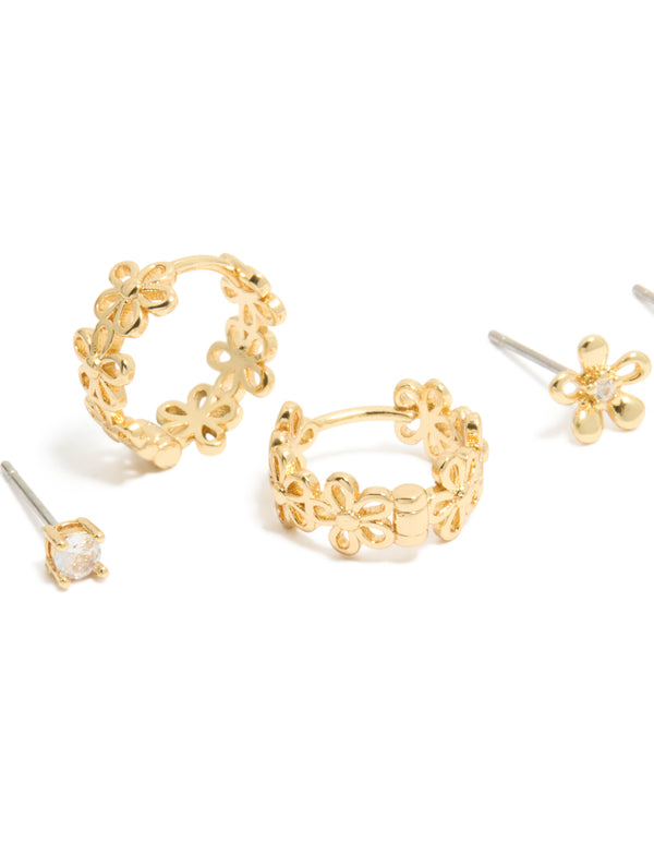 Featuring gold plated cubic zirconia outline flower studs and huggie earrings in a dainty 3-pack close up view