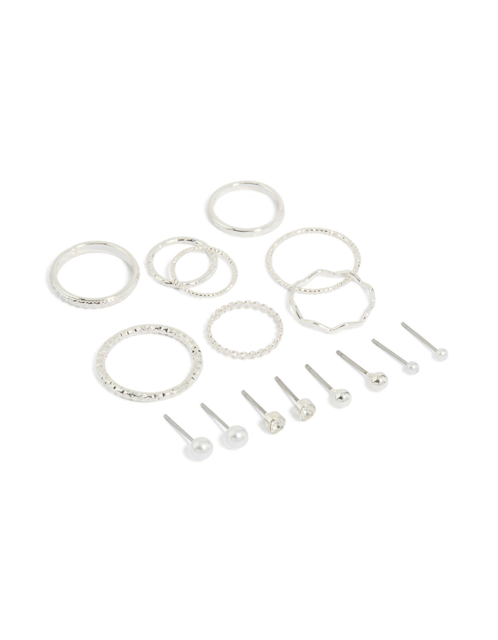 Showcasing dainty stud earrings featuring pearl and ball designs, along with rings in a 12-piece set with a silver finish front view