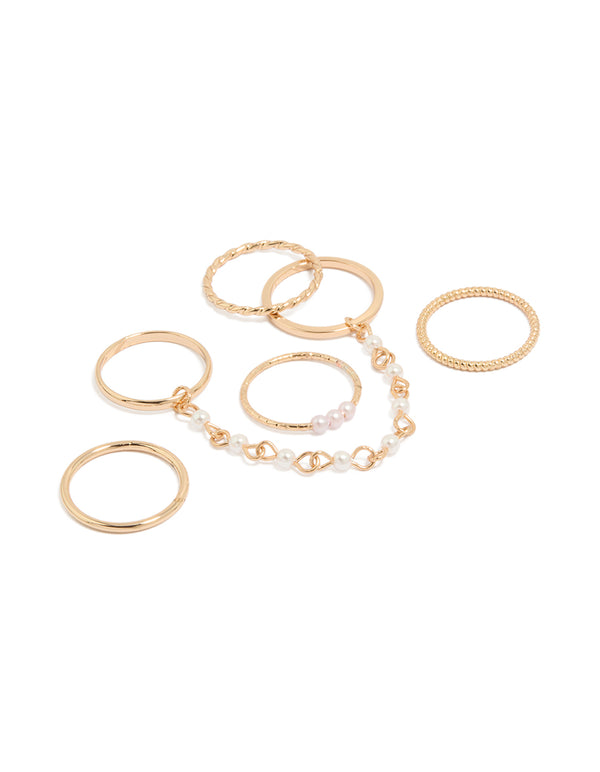 Showcasing a gold pearl chain and thin rings 6-pack with beaded charm accents front view
