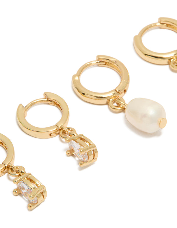 Featuring pearl huggie hoop 2-pack earrings crafted from gold plated cubic zirconia and crystal in ivory close up view