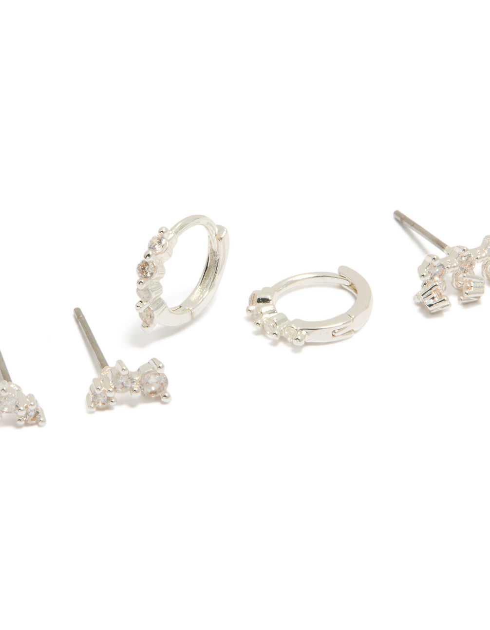 Designed with dainty silver plated cubic zirconia mini trio stud and huggie earrings in a 3-pack close up view