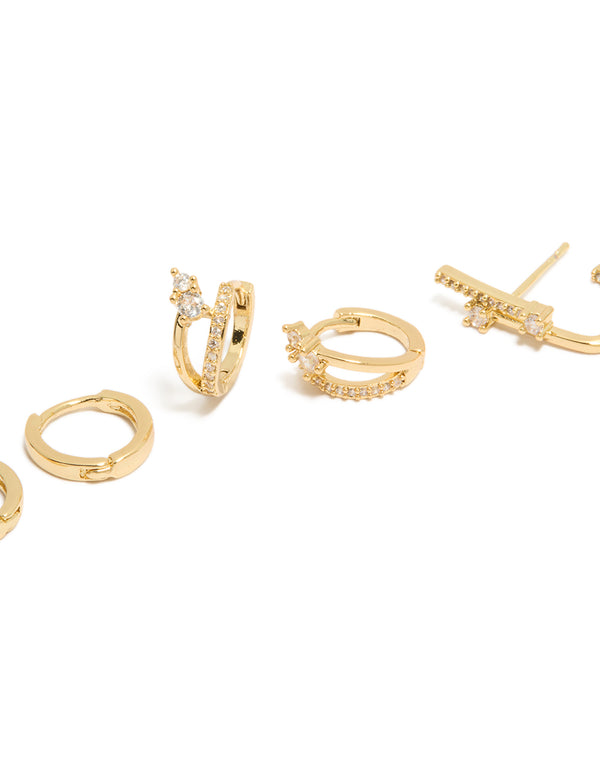 Highlighting gold plated studs and double cuff huggie earrings with cubic zirconia crystals in a 3-pack close up view