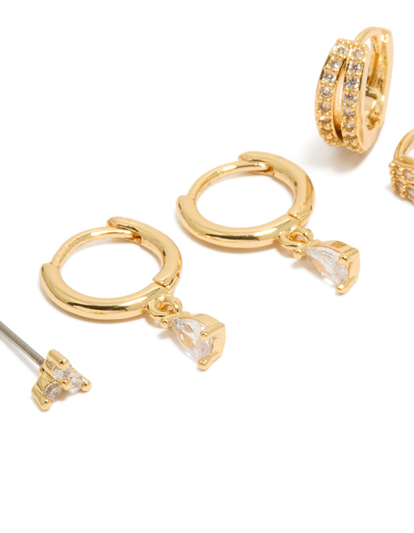 Showcasing a dainty huggie earrings 3-pack with cubic zirconia and crystal featuring gold plated material in gold color close up view