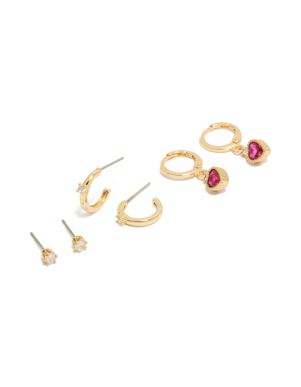 Showcasing gold plated cubic zirconia studs and heart huggie earrings with charm featuring crystal closure hoop in a 3-pack set front view