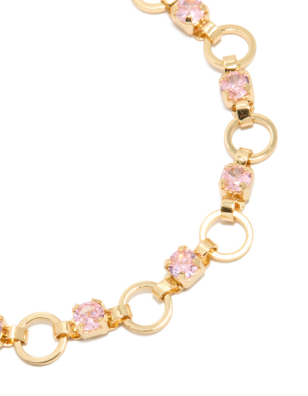 Featuring gold plated alternating pink cubic zirconia round link bracelet with chunky craftsmanship in light pink and gold close up view
