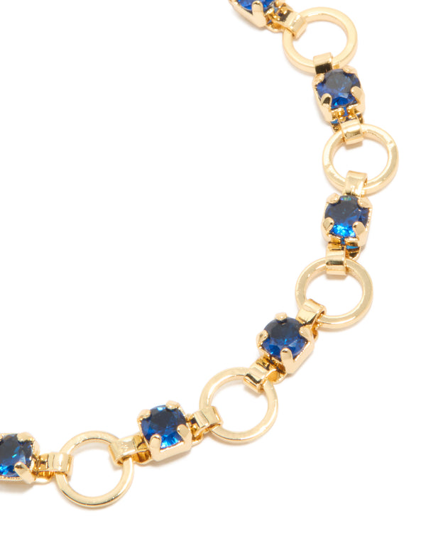 Highlighting gold plated blue cubic zirconia alternating round link bracelet with stone cut design close up view