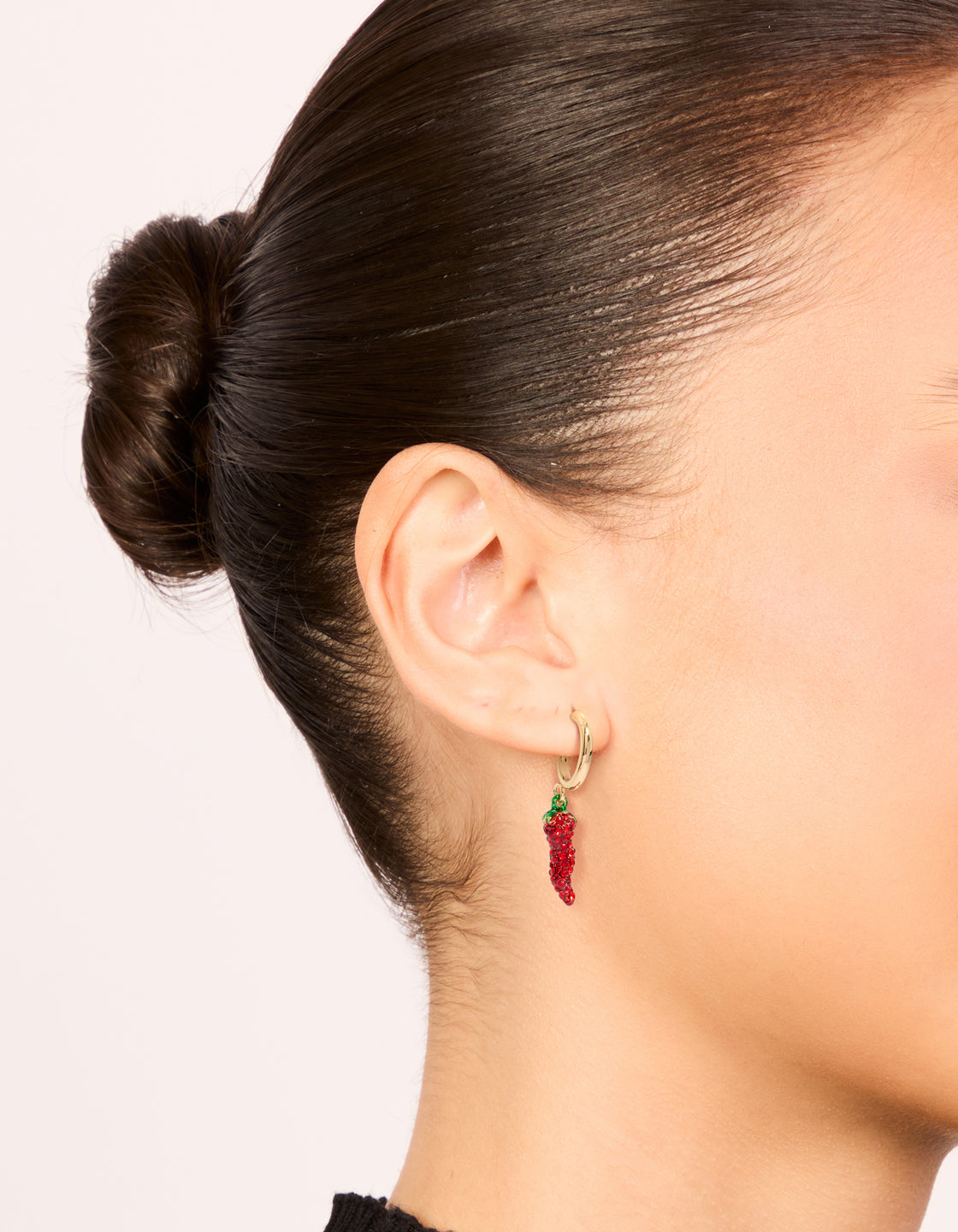 Crafted from gold diamante chili hoop earrings with food in red and green on ear view