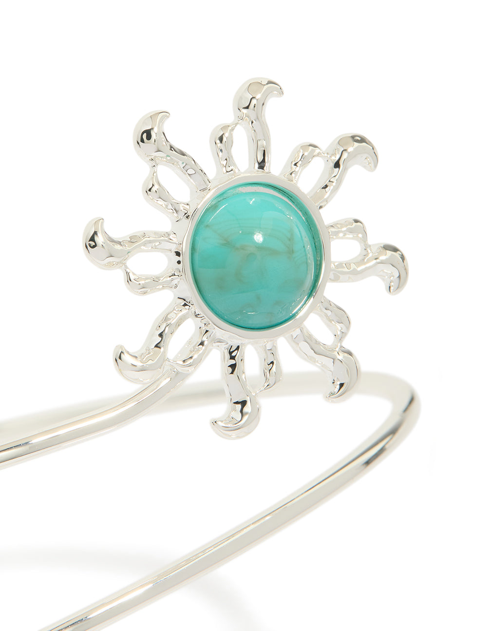 Showcasing a celestial statement bracelet in silver featuring turquoise stone and swirl design close up view