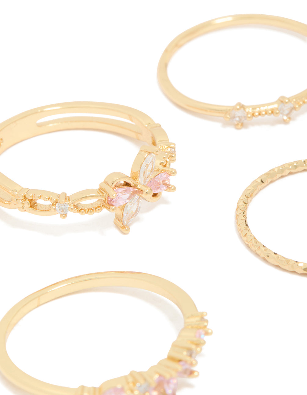 Detailed view of gold pink and clear cubic zirconia flower rings 5-pack with butterfly featuring crystal in white close up view