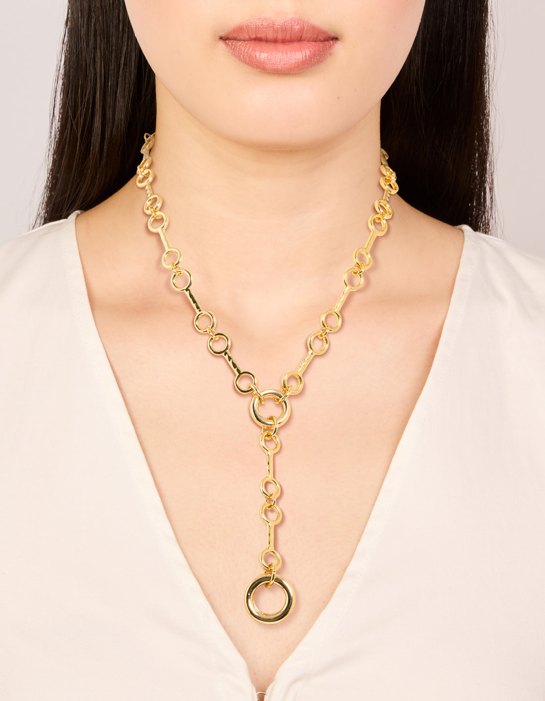 Showcasing a gold plated multi organic circle Y-necklace on neck view