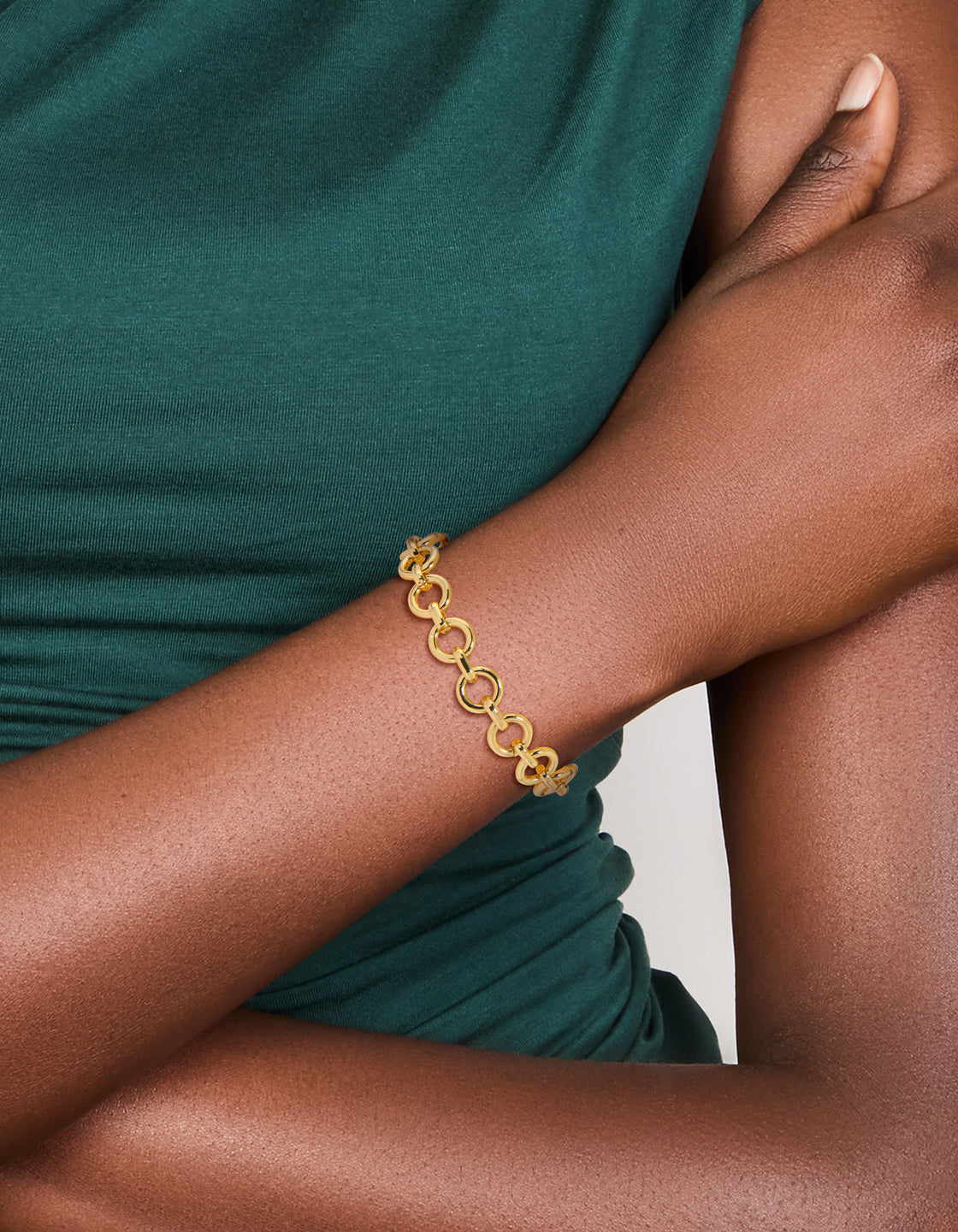 Featuring a gold plated statement circle link bracelet on wrist view