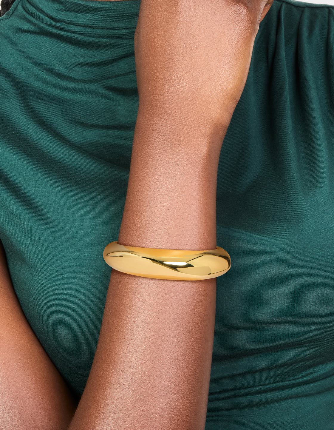 Featuring a gold plated thick organic chunky bangle in statement style on wrist view