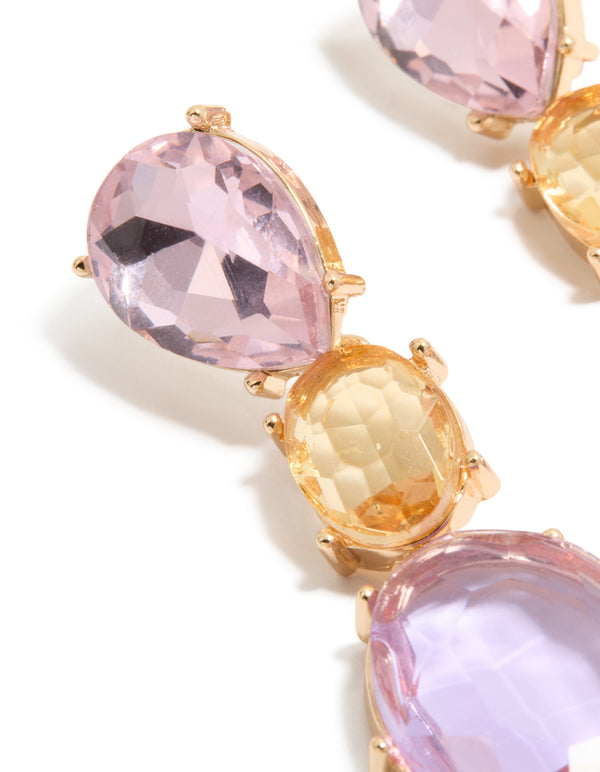Designed with statement drop earrings featuring oval cut stones in purple and orange hues set in gold close up view