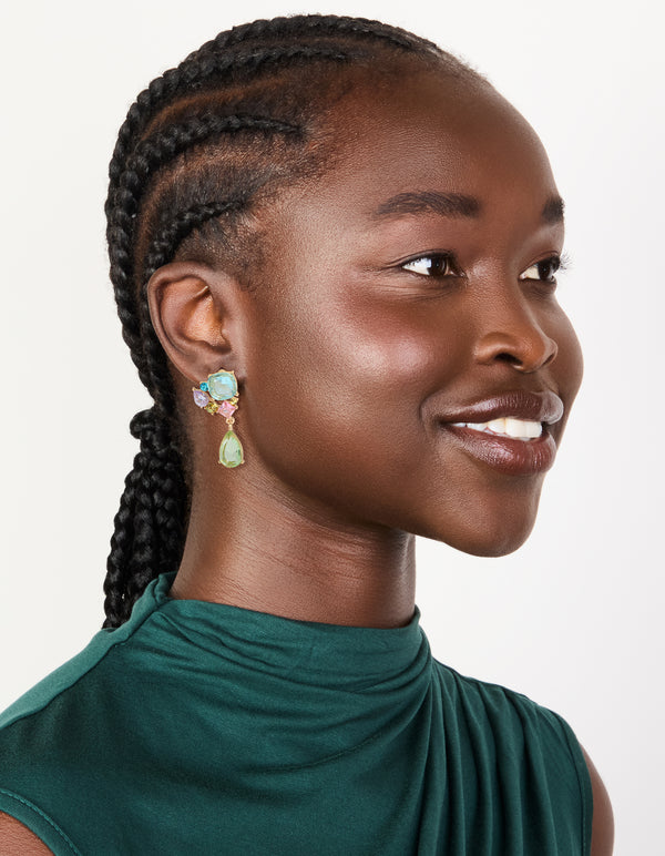 Designed with statement drop earrings featuring gold finish and multicolored diamante cluster in aquamarine, pale green, and pink tones on model view