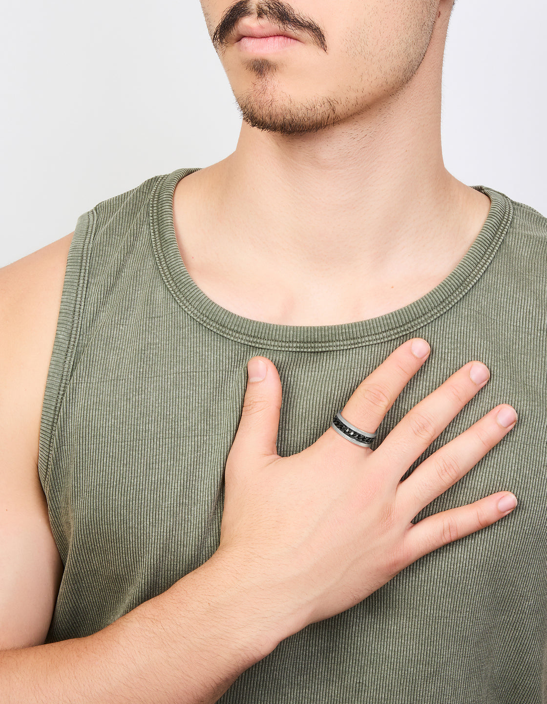 Featuring a mens waterproof stainless steel band ring with black chain detail in silver on finger view