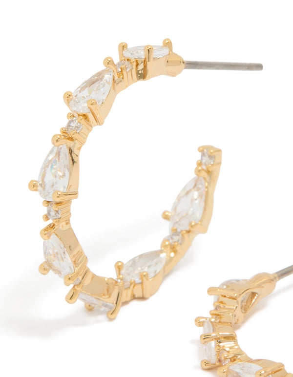 Featuring teardrop medium open hoop earrings in gold plated finish with cubic zirconia close up view