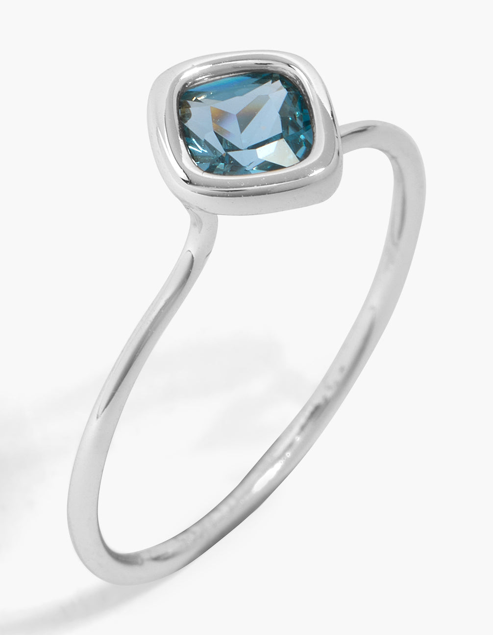 Elegant sterling silver solitaire blue cubic zirconia ring with crystal detailing in light blue front view
