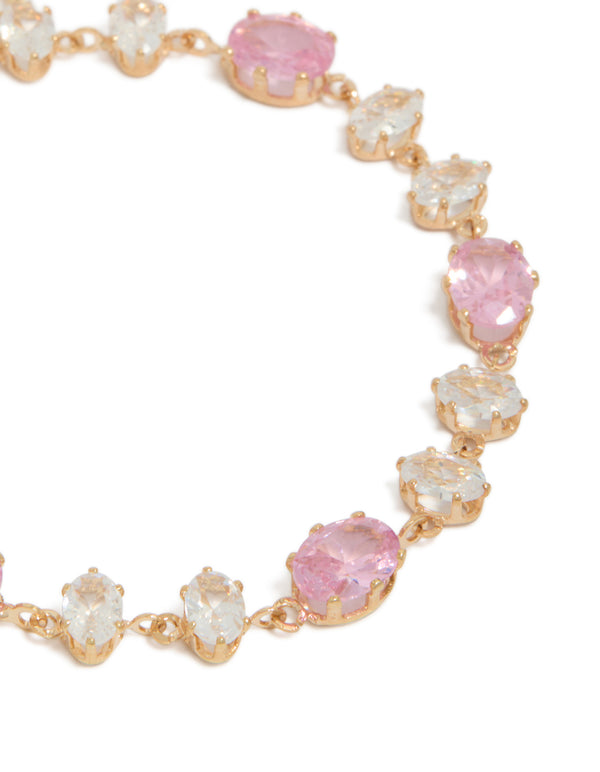 Crafted with accents, this bracelet showcases round stone cut in gold, pink and clear diamantes close up view