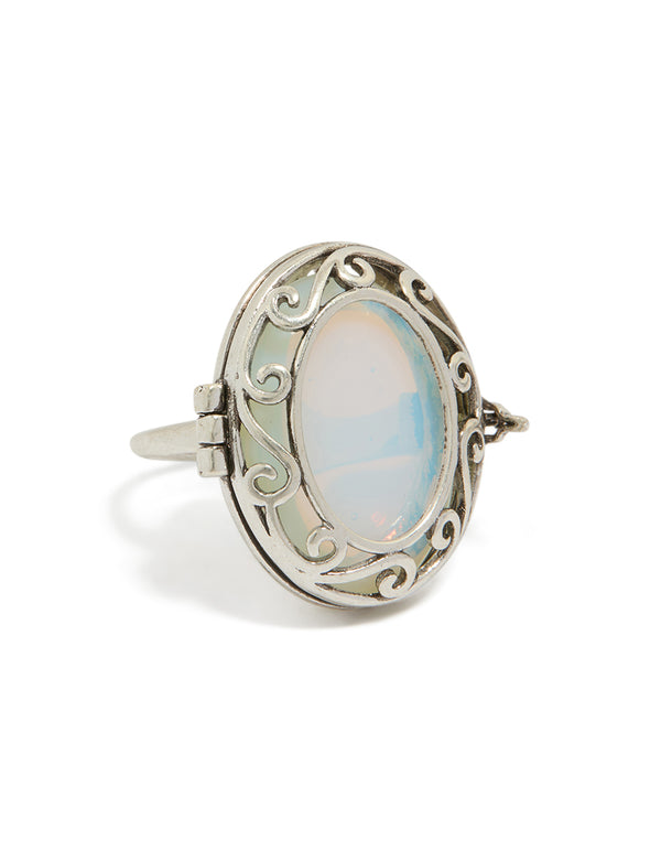 Showcasing an antique silver oval stone locket ring in pale turquoise and statement style front view