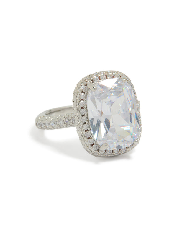 Showcasing a statement ring with cushion cut cubic zirconia crystal centerstone, halo setting, and silver band front view