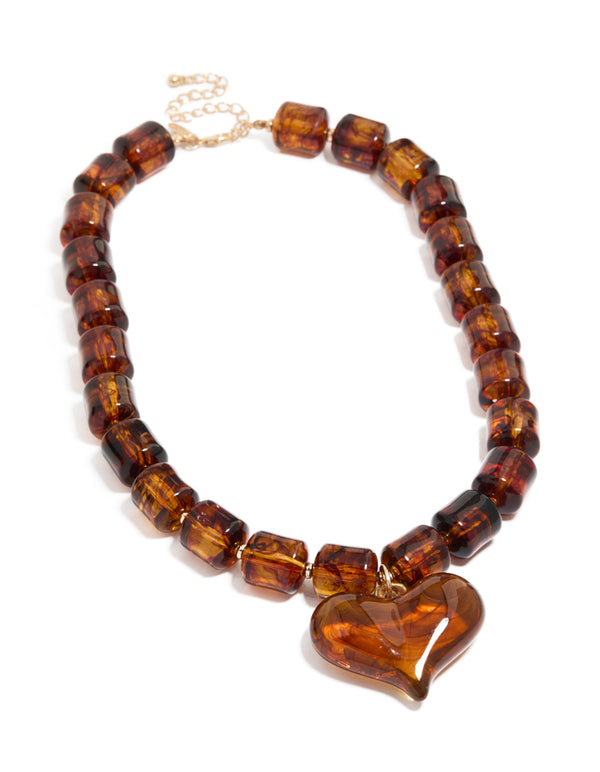 Designed with brown square beads and heart necklace in statement gold tones front view