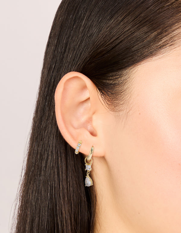 Beautifully designed waterproof gold plated stainless steel huggie drop earrings in a 2-pack with cubic zirconia and crystal accents on ear view
