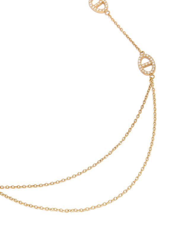 Showcasing a waterproof double chain necklace with charm featuring oval cut cubic zirconia in gold plated stainless steel close up view