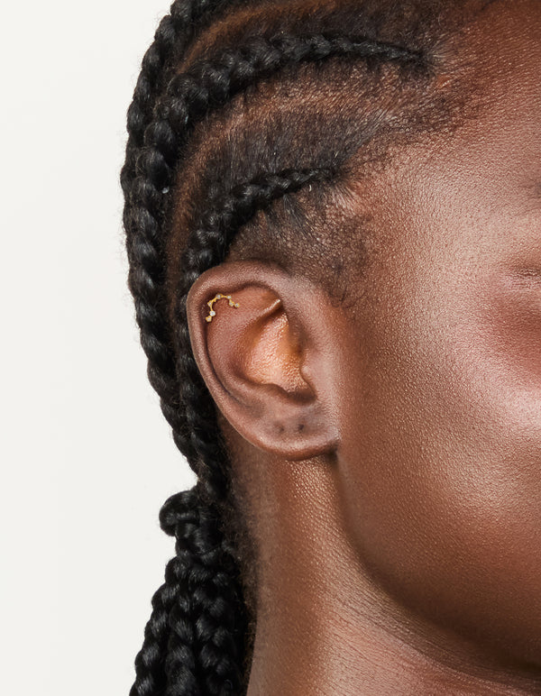 Featuring celestial constellation flat back stud with cubic zirconia in surgical steel gold plated on ear view