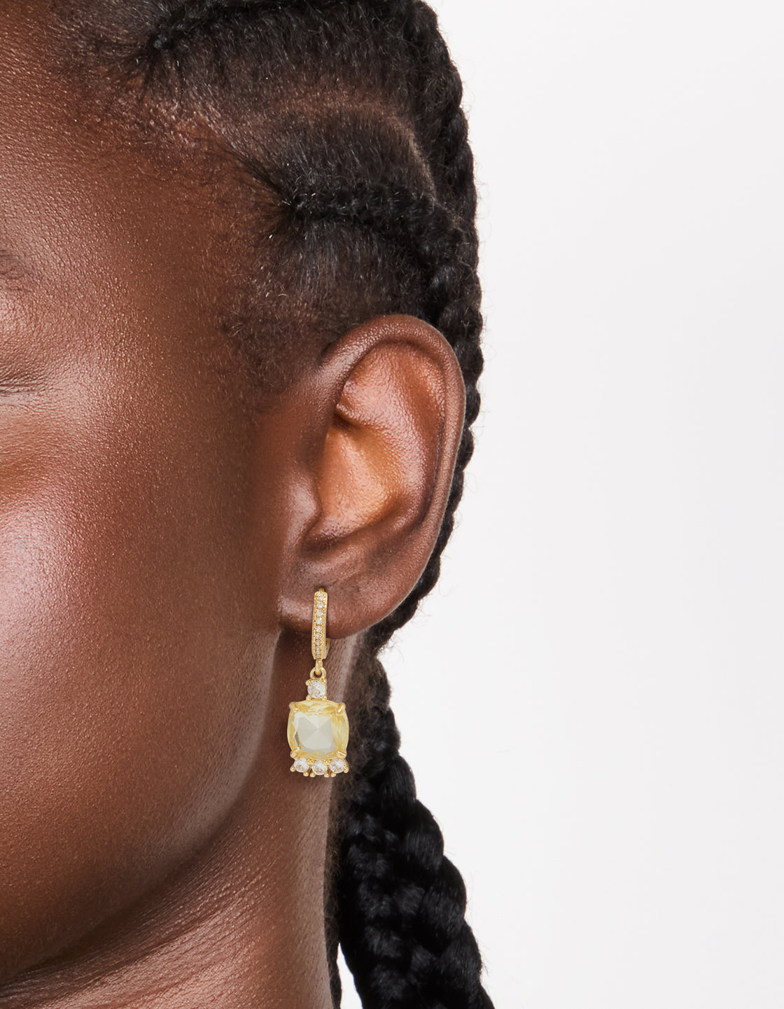 Elegant gold plated cubic zirconia yellow square drop huggie earrings with hoop closure in clear on ear view