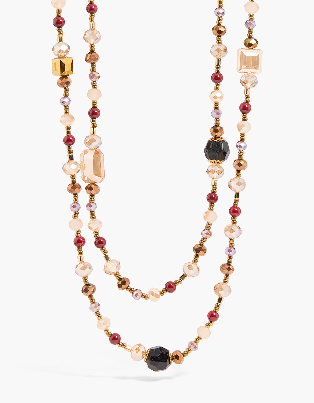 Showcasing a gold long beaded layered necklace with maroon and black accents close up view