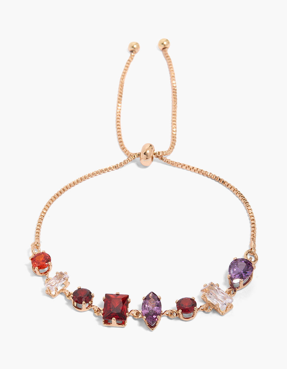 Showcasing a toggle bracelet in gold with mismatched shaped red, purple, and clear accents cubic zirconia front view