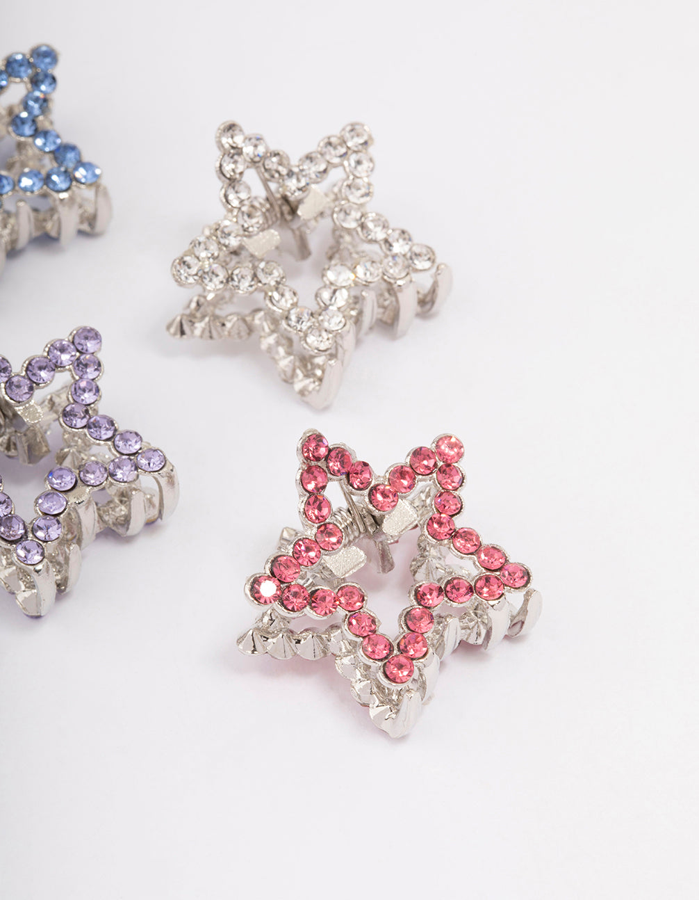 Crafted with celestial star accents, this silver mini diamante hair claw clip 4-pack detail view