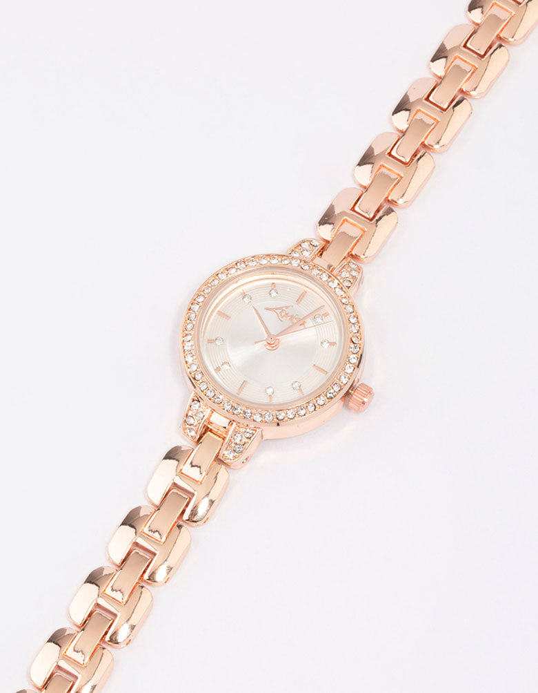 Showcasing a diamante small strap watch with white dial, stone look, round shape, designed for women, casual occasion, link band, rose gold strap color, analog type, watch face detail view