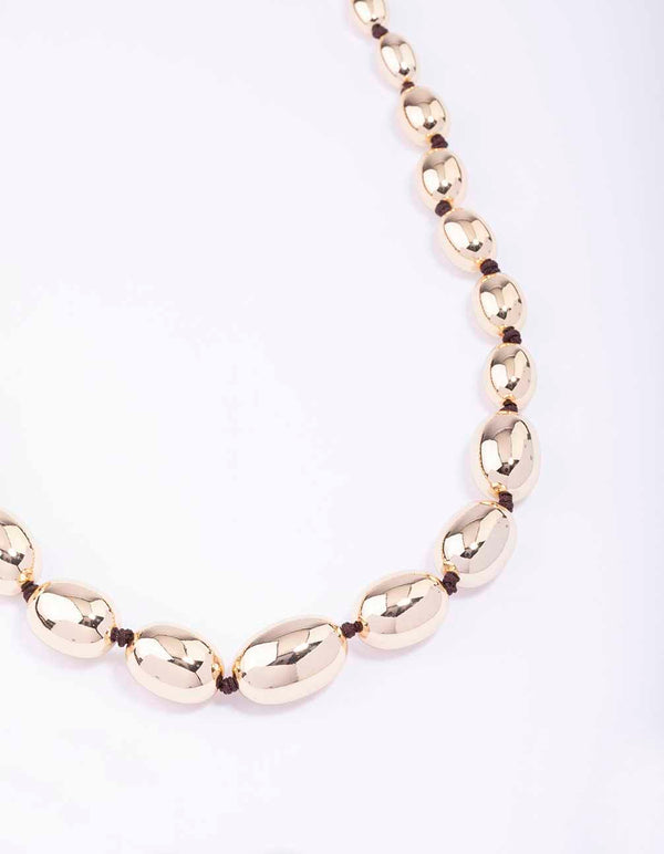 Gold Oval Bead Graduating Cord Necklace