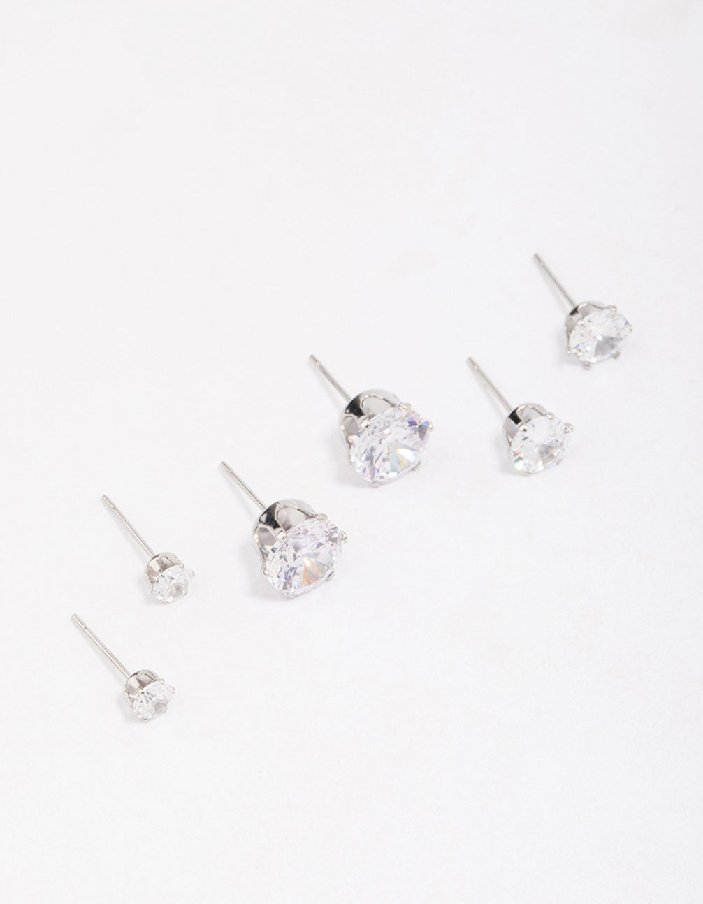 Showcasing waterproof stainless steel graduating cubic zirconia earring 3-pack with stud closure in silver front view