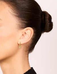 Showcasing gold plated sterling silver cubic zirconia butterfly earrings in purple on ear view - link has visual effect only