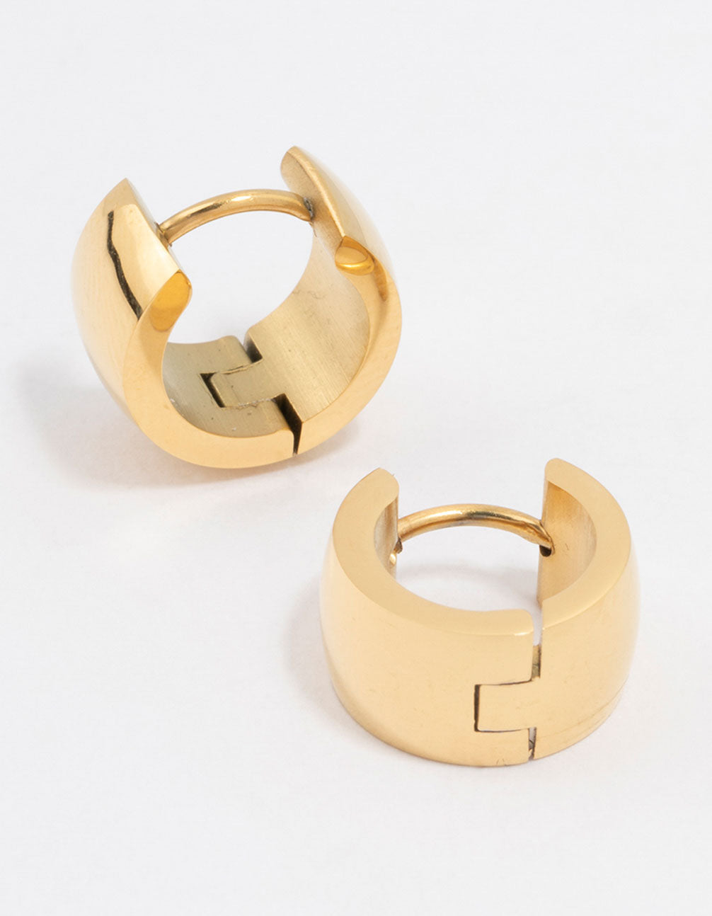 Showcasing waterproof gold plated stainless steel huggie hoop earrings with polished finish front view