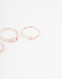 Crafted with baguette and round stone cuts, this rose gold plated cubic zirconia ring set is displayed in close up view - link has visual effect only