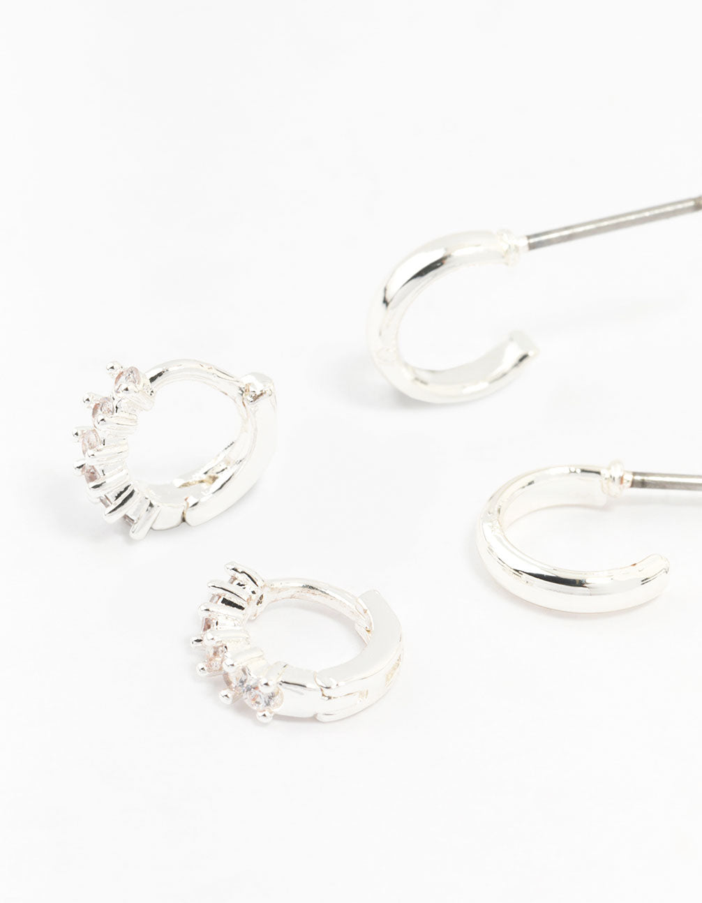 Showcasing statement silver mixed diamante huggie hoop earrings in a 3-pack close up view