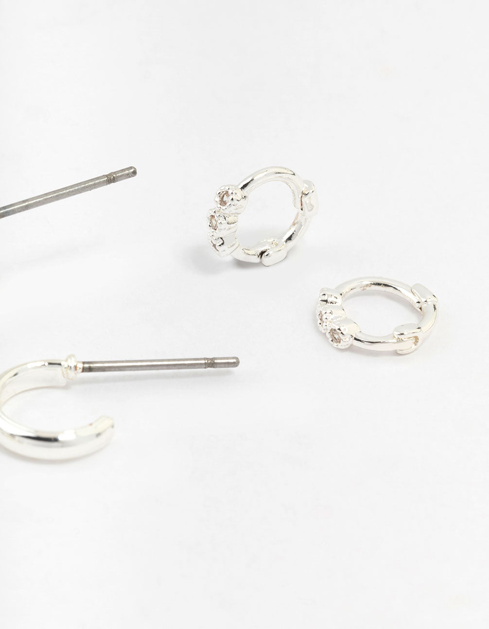 Featuring statement silver mixed diamante huggie hoop earrings in a 3-pack post detail view