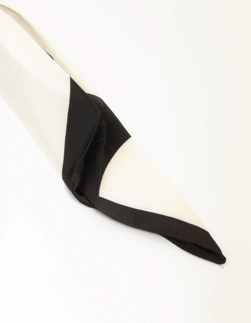 This classic black scarf features geometric fabric design with white accents detail view