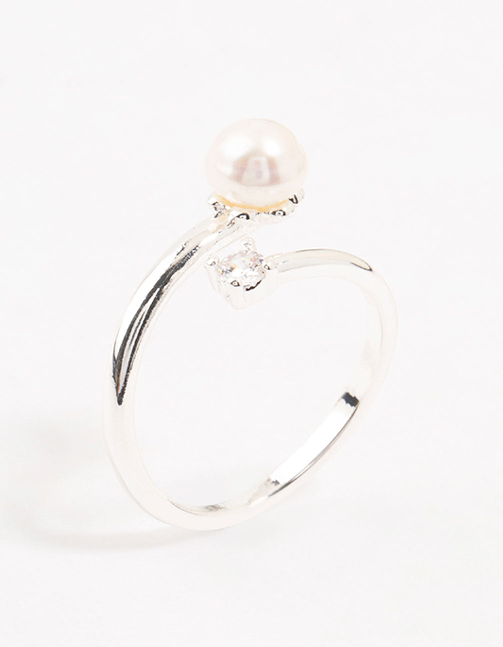 Showcasing a dainty silver plated ring wrapped with cubic zirconia and pearl accents side detail view